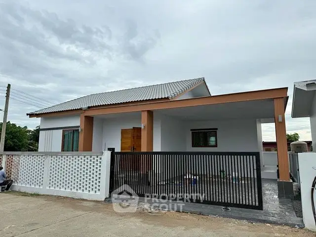 Charming single-story home with modern design and gated entrance, perfect for family living.