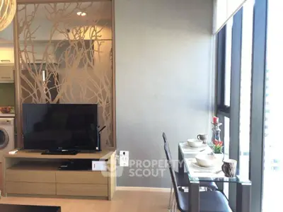 Modern living room with stylish decor and large windows offering natural light.