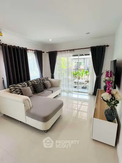 Stylish living room with modern decor and large windows for natural light.