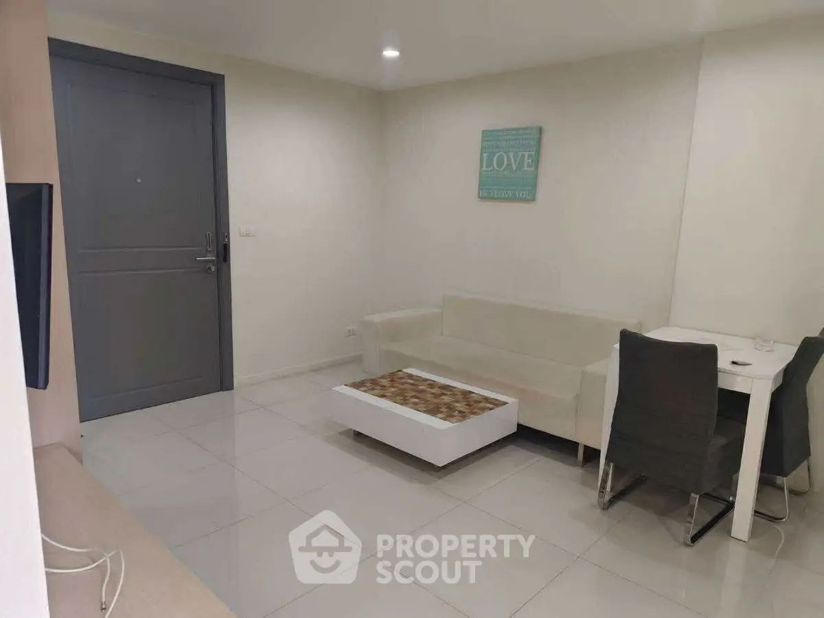 Modern living room with cozy sofa and stylish coffee table in a minimalist apartment.