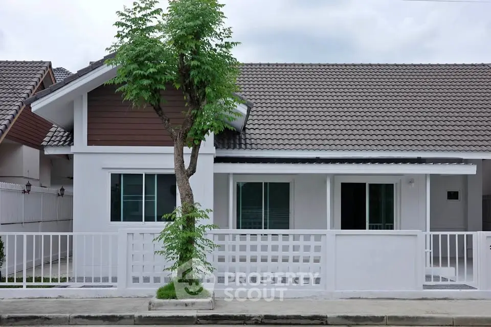 Charming single-story house with modern design and fenced front yard in a serene neighborhood.