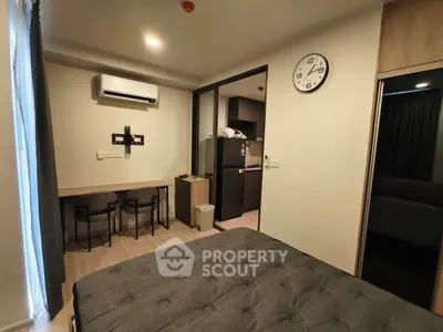 Modern studio apartment with cozy bedroom and compact kitchen