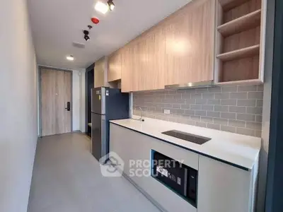 Modern kitchen with sleek cabinetry and built-in appliances in a contemporary apartment.