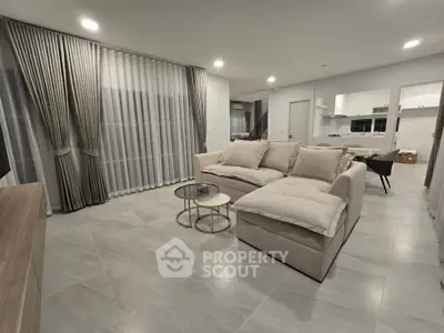 Spacious modern living room with elegant decor and open kitchen layout
