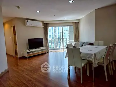 Spacious living room with dining area and balcony view in modern apartment