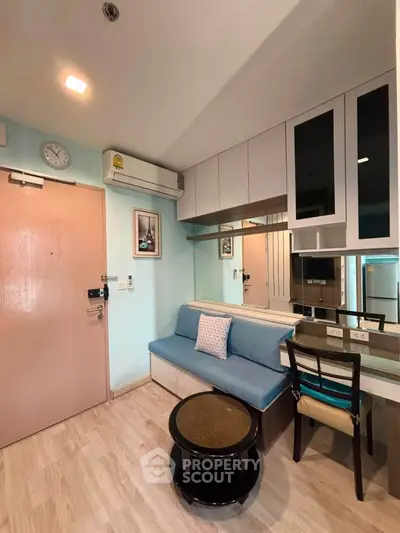 Charming compact living room with modern furniture and stylish decor in cozy apartment.