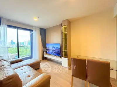 Modern living room with city view, leather sofa, and glass dining table in a high-rise apartment.