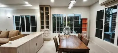 Spacious living room with modern furniture and large windows offering natural light.