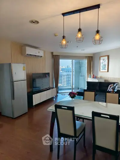 Modern living room with dining area, stylish lighting, and balcony view in urban apartment.