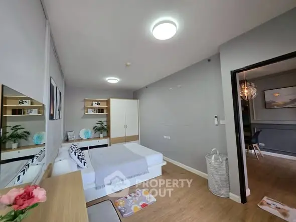 Modern bedroom with stylish decor and ample storage in a contemporary apartment.