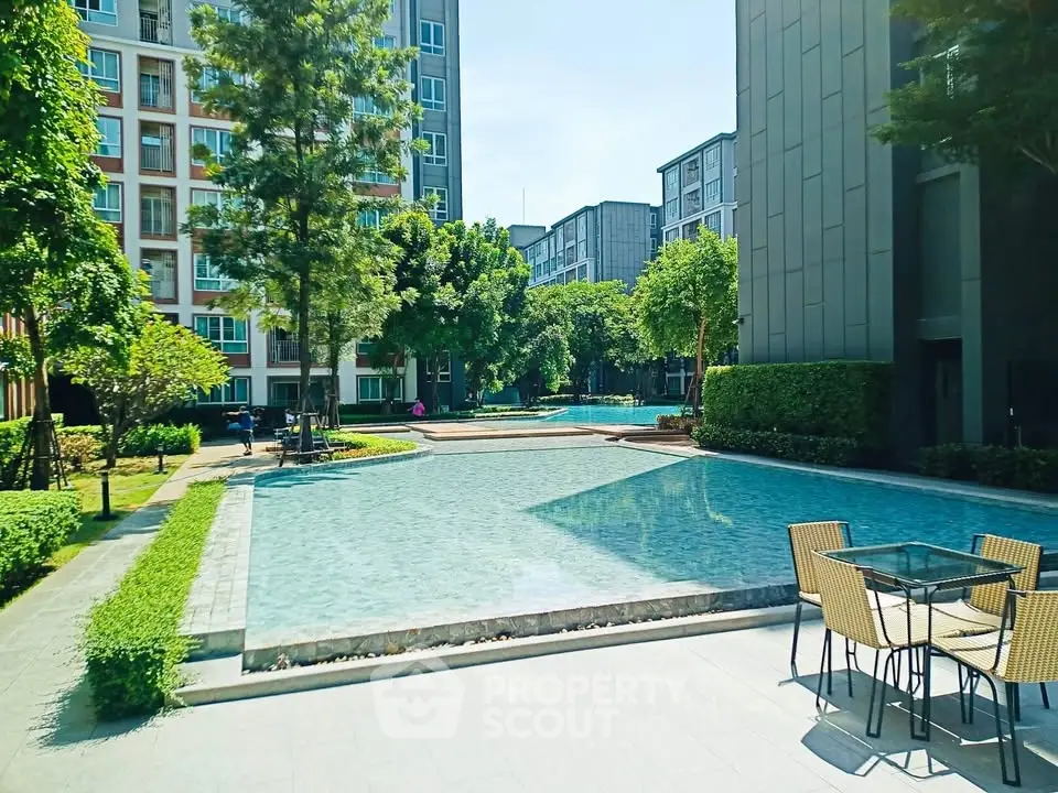 Luxurious apartment complex with serene pool and lush greenery