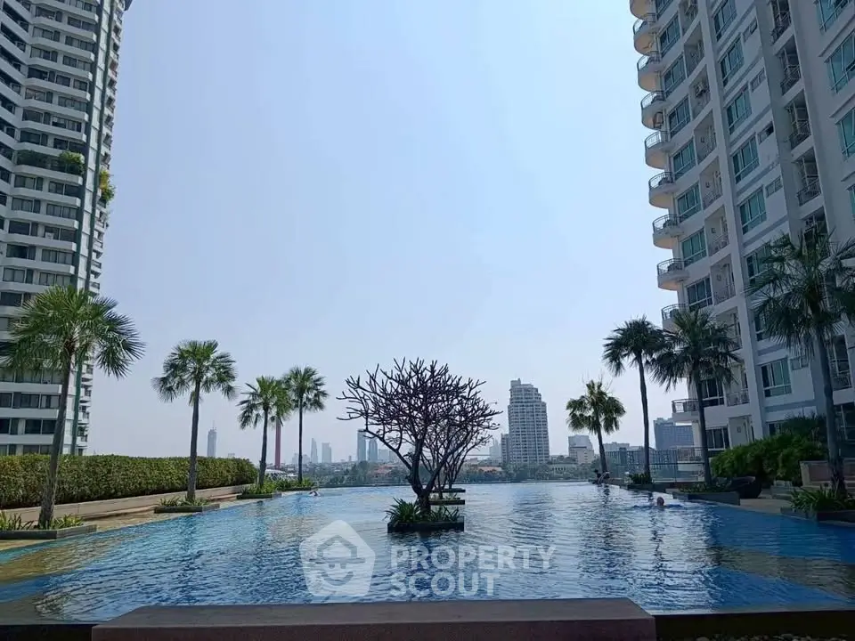 Luxurious high-rise apartment complex with stunning infinity pool and city skyline view.