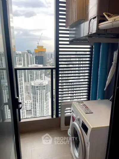 High-rise apartment balcony with washing machine and stunning city view.
