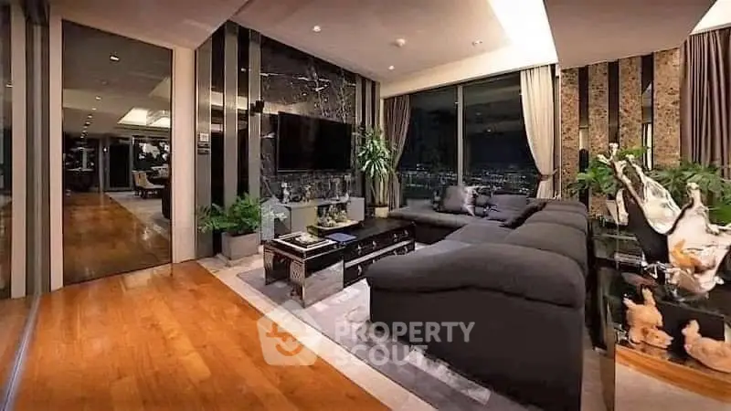 Luxurious modern living room with city view, elegant decor, and spacious seating area.