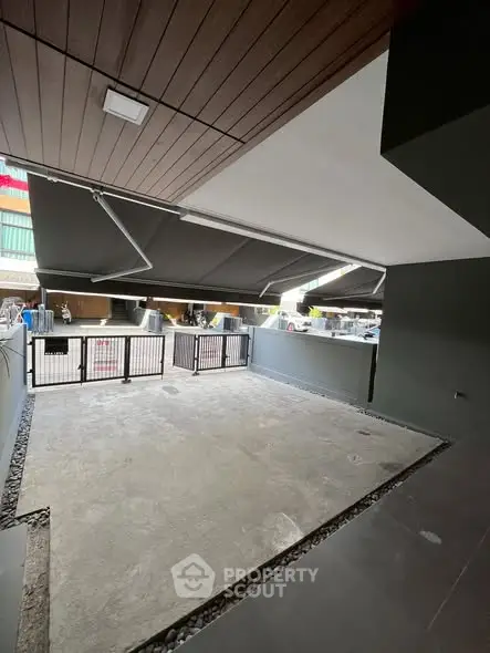 Spacious covered parking area with modern design and secure gate access.