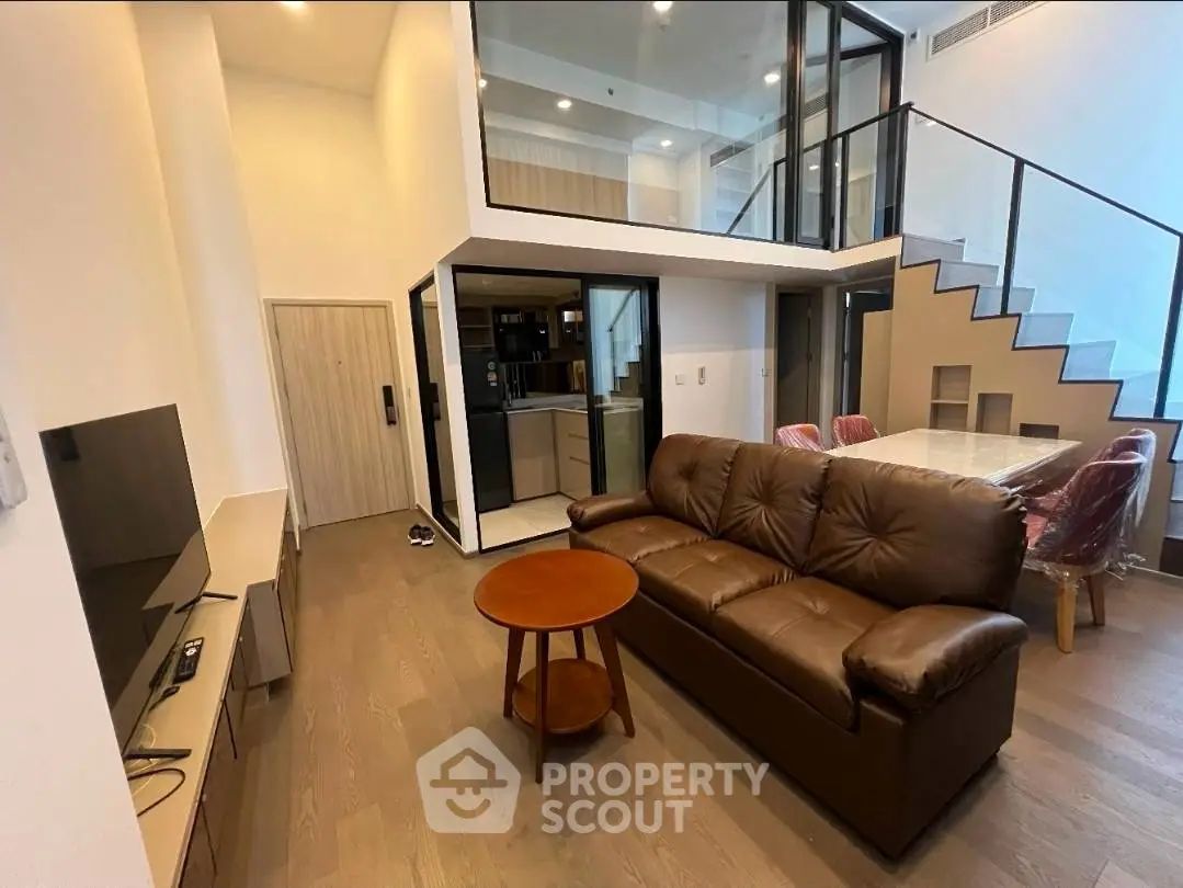 Modern duplex living room with high ceiling and stylish furniture