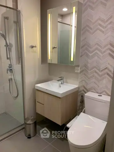 Modern bathroom with sleek fixtures and glass shower enclosure