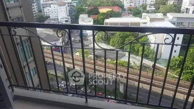 Spacious balcony with city view overlooking urban landscape and railway tracks.