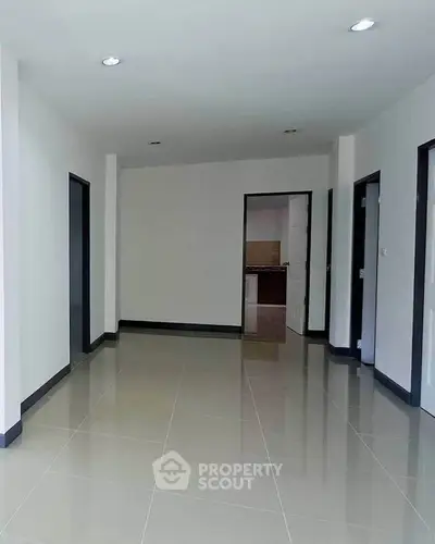 Spacious modern interior with sleek tile flooring and minimalist design, perfect for customization.