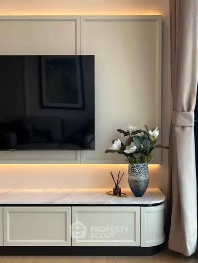 Elegant living room with mounted TV and stylish decor