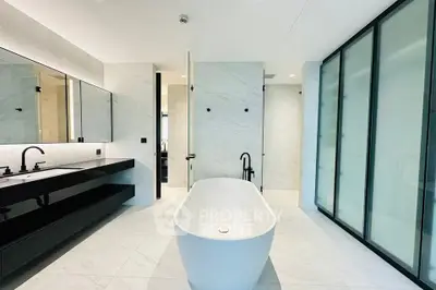 Luxurious modern bathroom with freestanding bathtub and sleek black fixtures