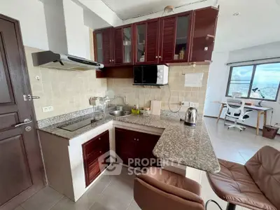 Charming kitchen with granite countertops and open layout, adjacent to a bright study area with city views.