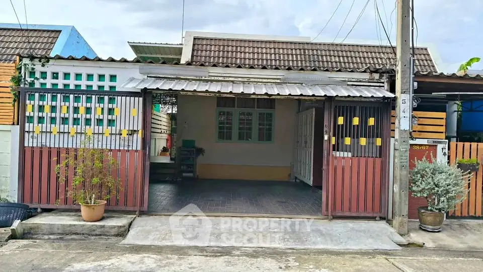 Charming single-story home with gated entrance and cozy front yard, perfect for small families or first-time buyers.