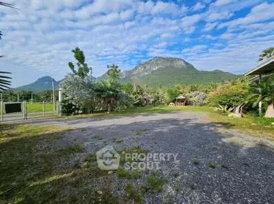 Scenic mountain view from spacious garden area in tranquil real estate setting.