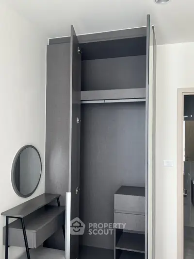 Modern minimalist bedroom with sleek wardrobe and vanity desk