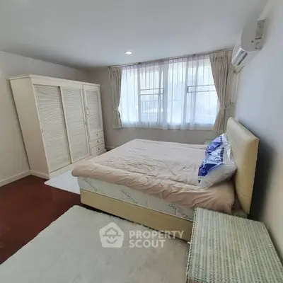 Spacious bedroom with elegant decor and natural light