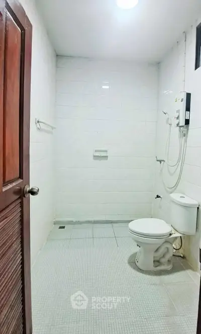 Spacious bathroom with modern shower and white tile design