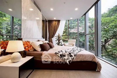 Luxurious bedroom with floor-to-ceiling windows and stunning garden view