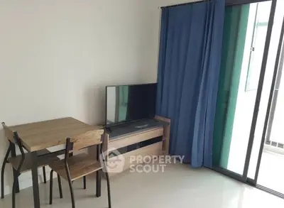 Modern living room with TV, dining table, and balcony access in a stylish apartment.