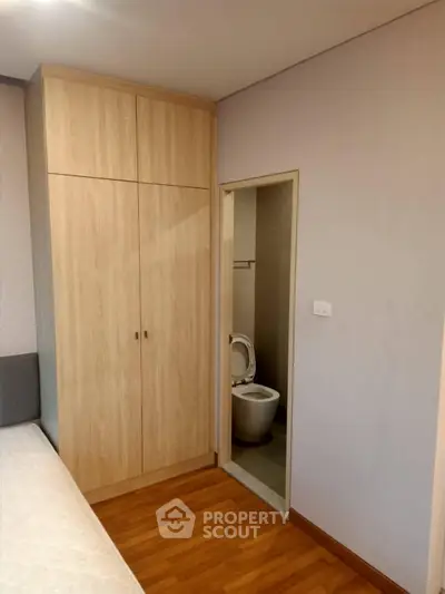 Cozy bedroom with wooden wardrobe and ensuite bathroom