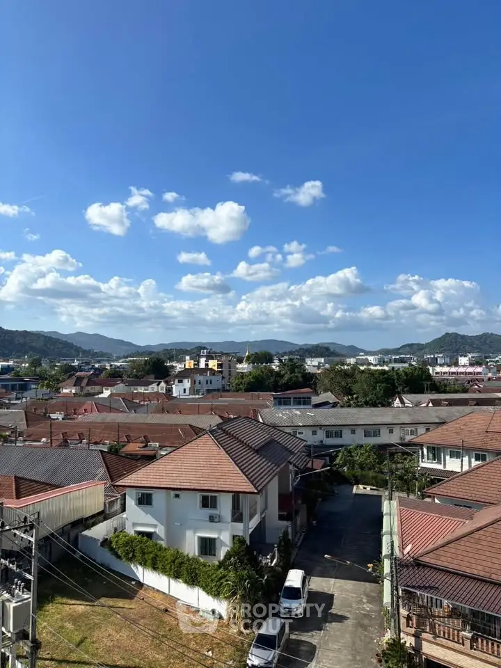 Scenic view of residential neighborhood with mountains in the background under a clear blue sky.