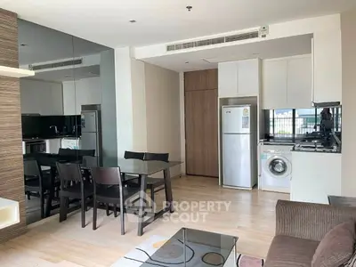 Modern open-layout kitchen and dining area with sleek appliances and stylish decor.