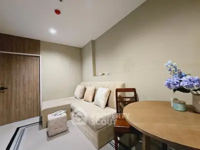 Cozy living room with beige sofa, wooden table, and elegant decor in modern apartment.