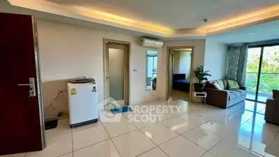 Spacious living room with modern decor and large windows for natural light.