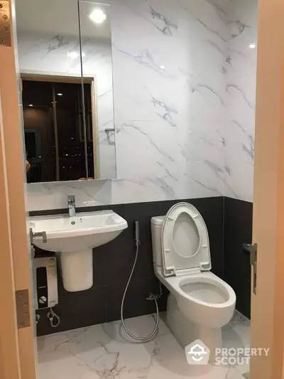 Modern bathroom with sleek fixtures and marble accents