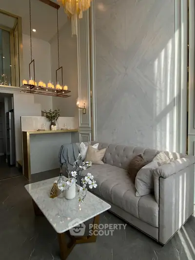 Luxurious living room with elegant chandelier and plush sofa in modern design