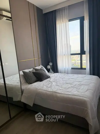 Modern bedroom with large window and stylish decor in urban apartment