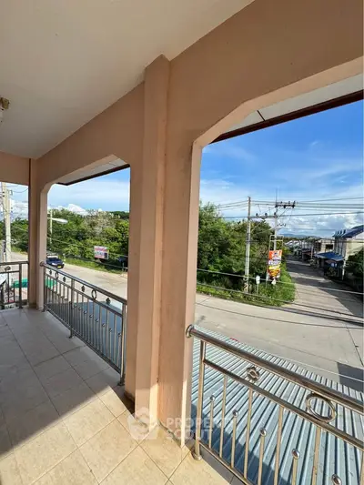 Spacious balcony with scenic street view, perfect for relaxation and enjoying the outdoors.