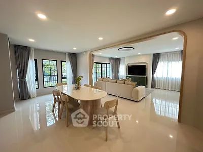 Spacious modern living room with elegant dining area and large windows for natural light.