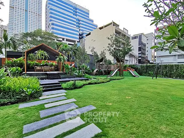 Lush garden with modern playground in urban residential complex