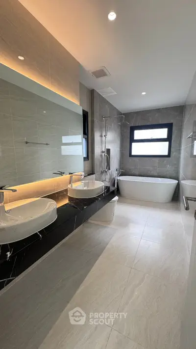 Luxurious modern bathroom with dual sinks and freestanding bathtub
