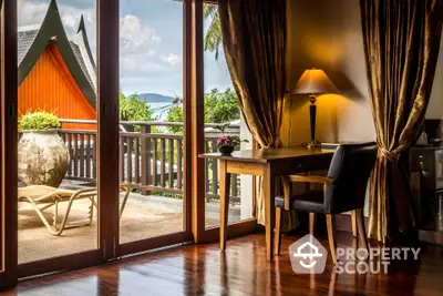 Luxurious room with elegant decor and stunning balcony view in tropical setting.