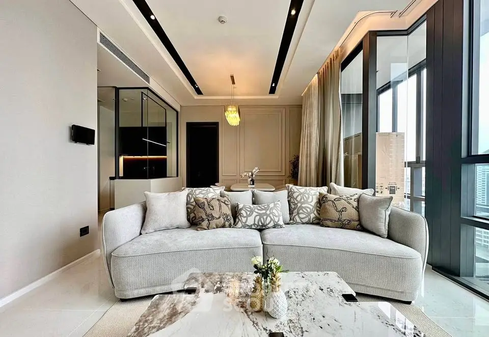 Luxurious modern living room with elegant decor and panoramic city views.