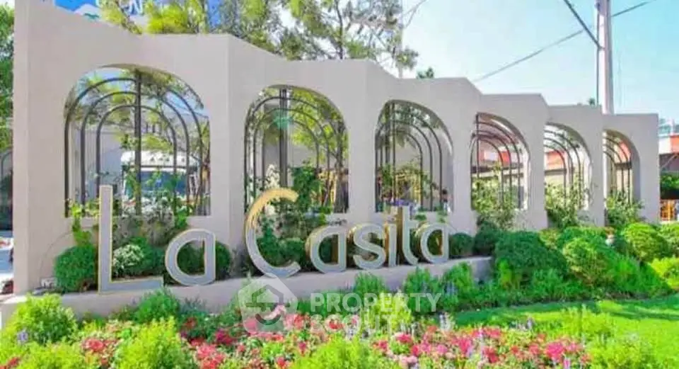 Elegant entrance of La Casita with lush greenery and modern design.