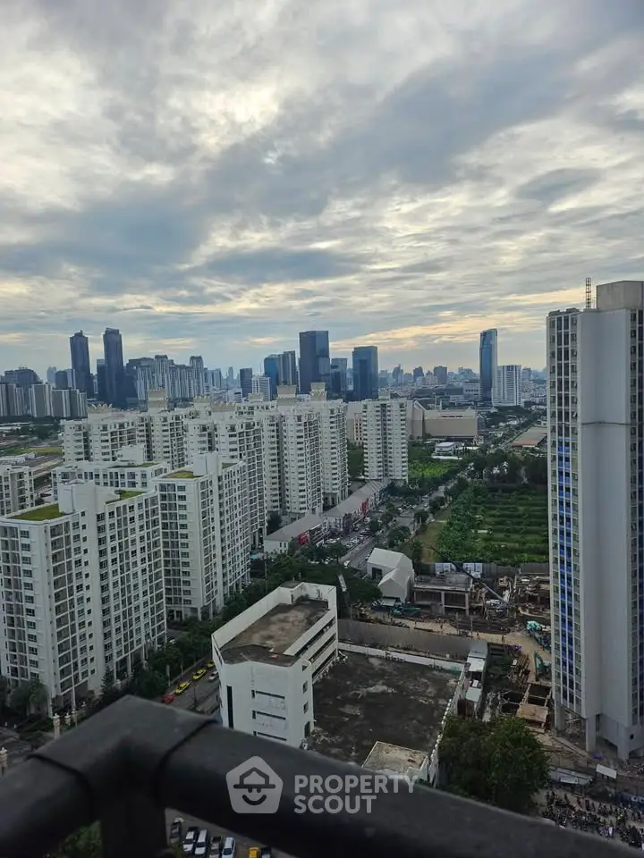 Stunning cityscape view from high-rise balcony overlooking modern skyline.