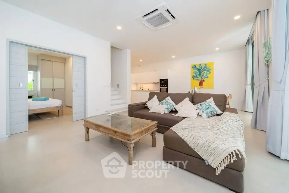 Spacious modern living room with open kitchen and cozy decor